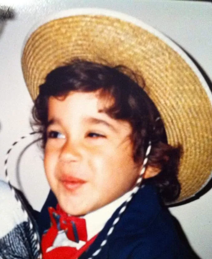 Charles V. as a small child in a straw hat and red bow tie, early family photograph